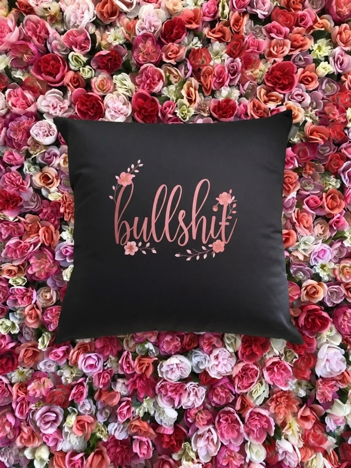 Black Bullshit Pillow on floral background